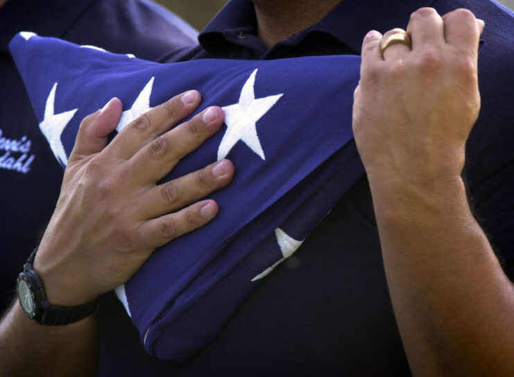 Close-up of someone holding an American flag folded into a triangle