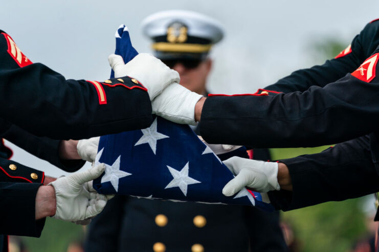 US Marines folding the American flag into a triangle