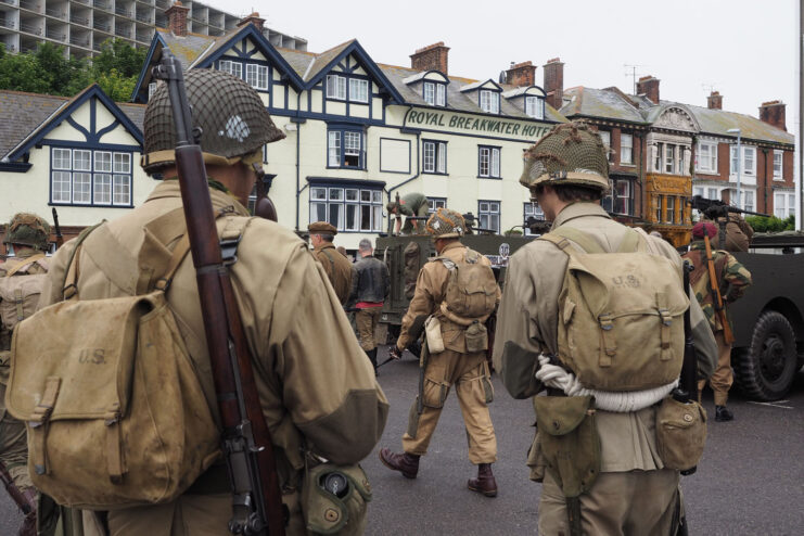 Men dressed as soldiers during the Second World War walking through a town