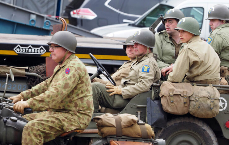Men dressed as soldiers from the Second World War sitting in a Jeep