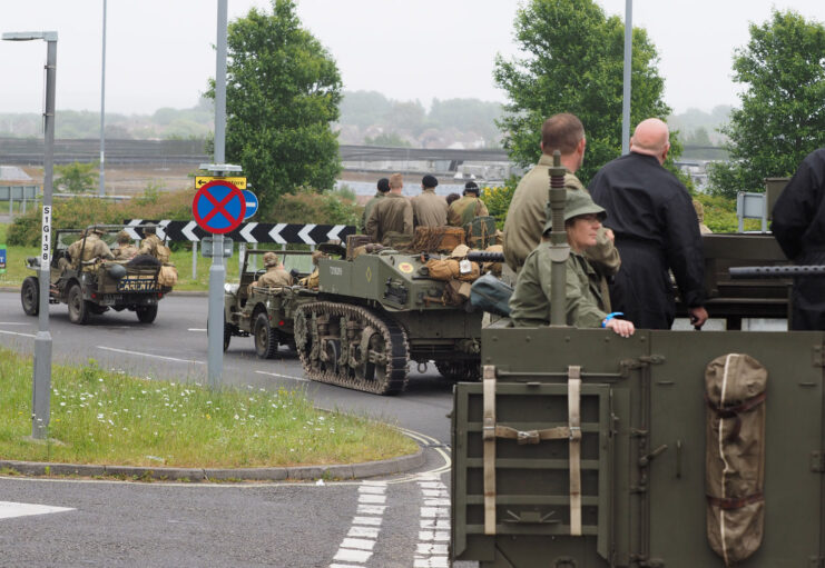 World War II-era vehicles driving down a road