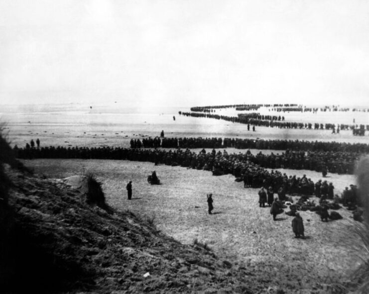 British Expeditionary Force (BEF) troops walking along a beach, into the English Channel