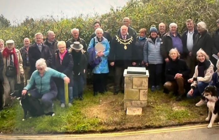 Crowd gathered around the Exercise Tiger memorial