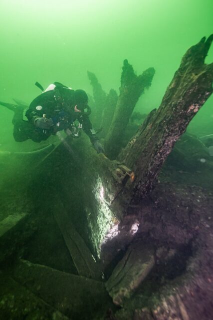 Diver examining what remains of the stern of Gribshunden on the seafloor