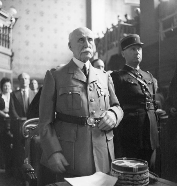 Henri Philippe Pétain standing in a courtroom with other individuals