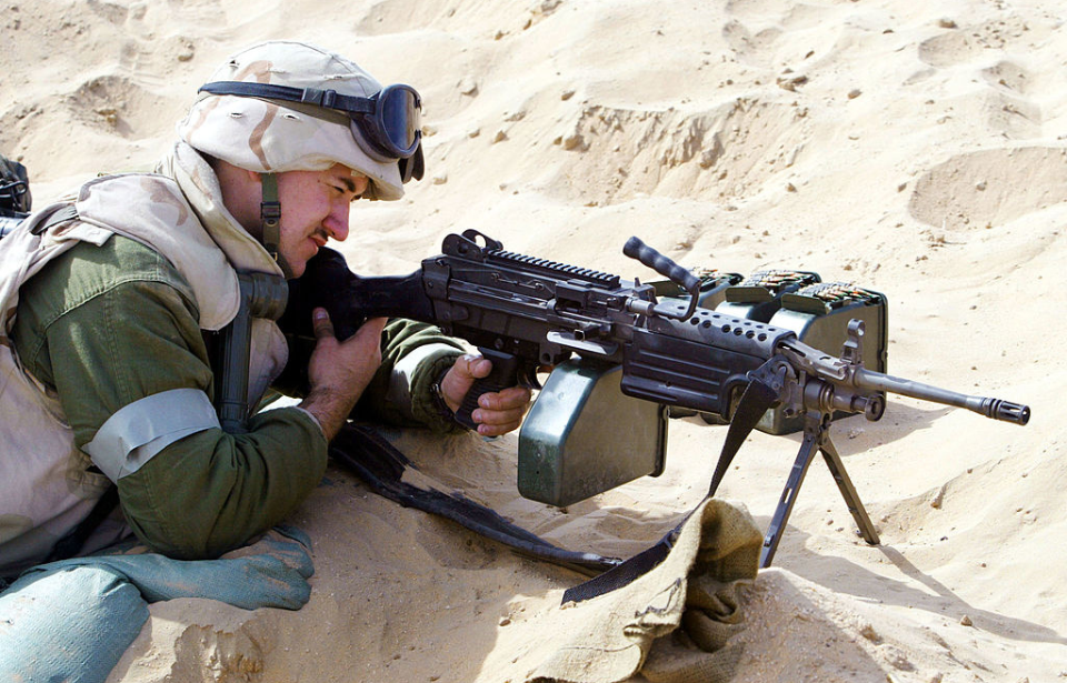 Spc. Shawn Kennedy looking through the sight of an M249 SAW machine gun