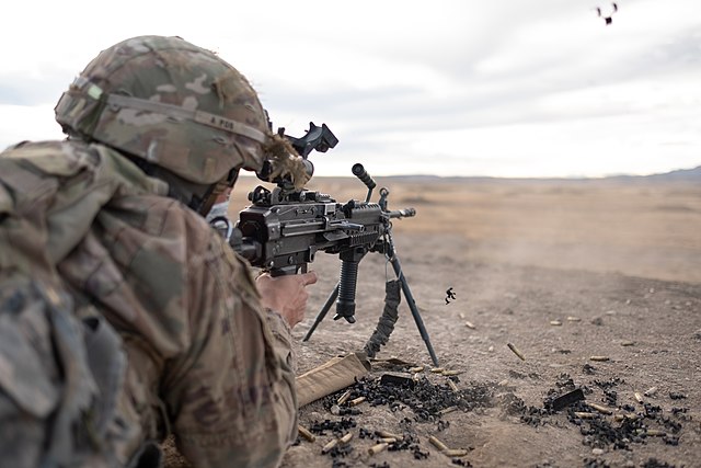 Pfc. Azad Anvarian firing an M249 SAW machine gun