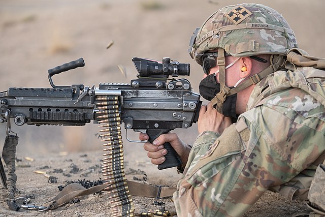 Pvt. Brooks Rochelle firing an M249 SAW machine gun