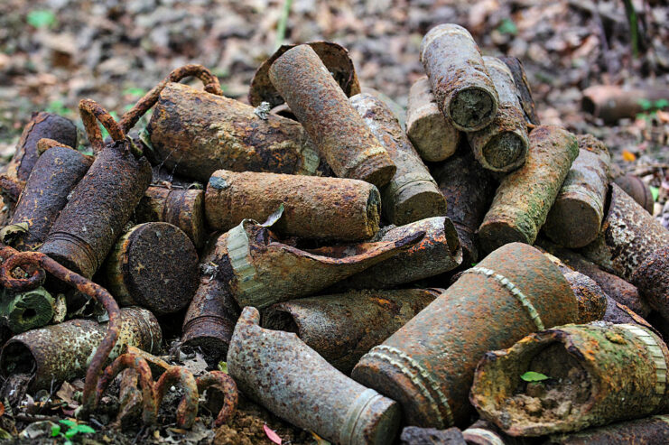 Pile of rusty artillery shells on the ground