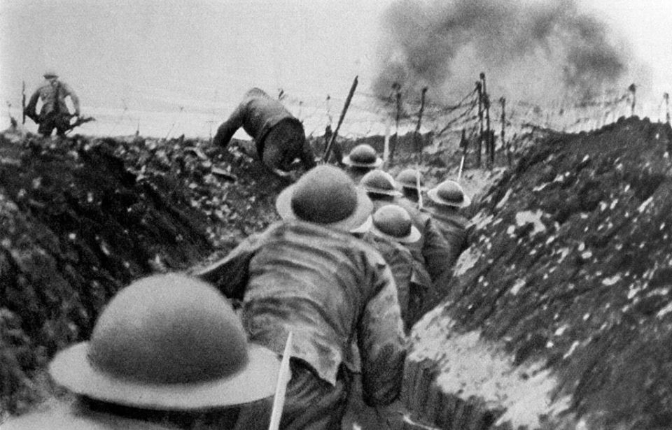 British soldiers running along a trench