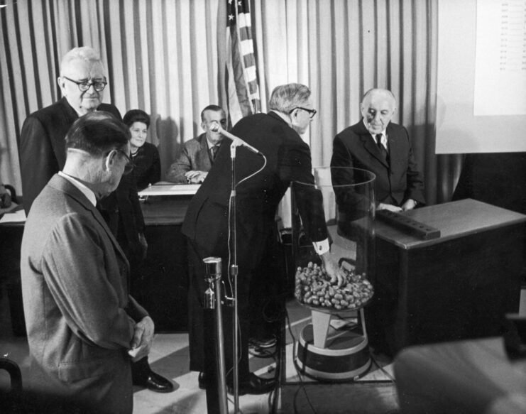 Alexander Pirnie grabbing a capsule from a jar while others watch