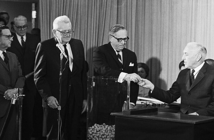 Alexander Pirnie standing with other government officials on a stage