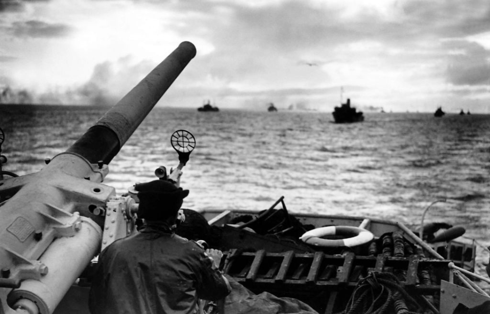 Gunner standing on the deck of a destroyer at sea