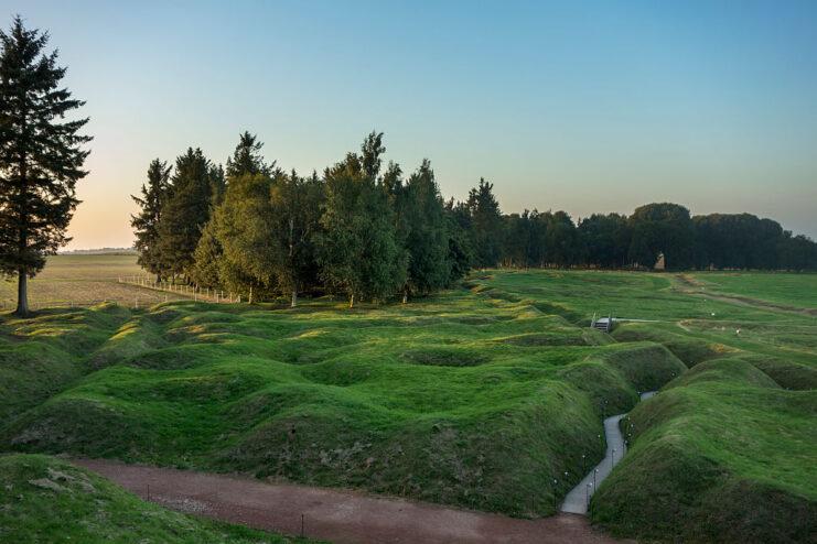 Craters surrounding a World War I-era trench in the middle of a grassy field