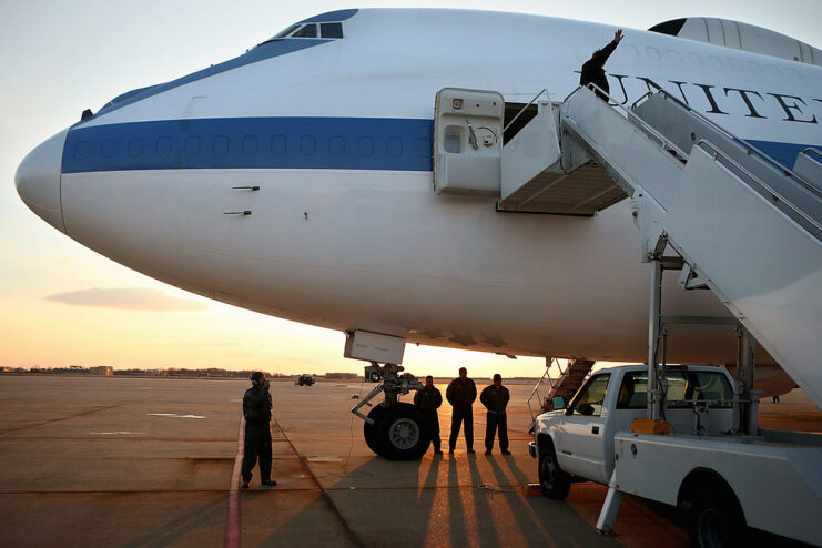 Leon Panetta waving from the door of a Doomsday plane parked on the tarmac