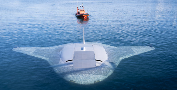 Overhead view of the Manta Ray UUV being towed by a ship in the water