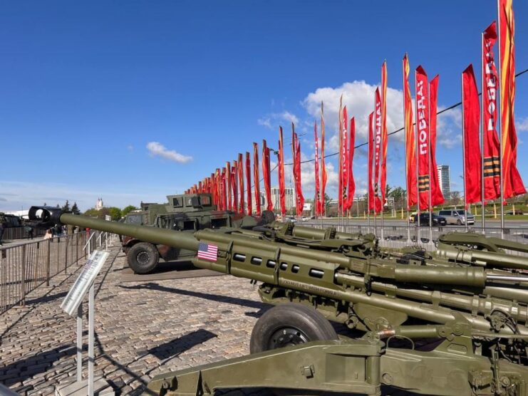 Military weapons lined up in a row outside