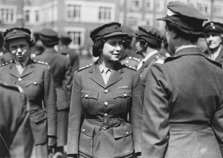 Queen Elizabeth II at a parade wearing her military uniform. 