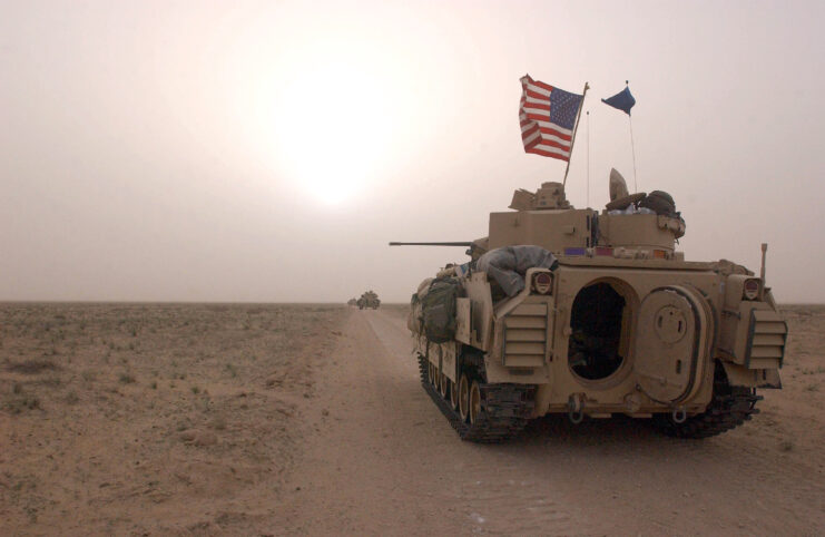 U.S. Army 3rd Division 3-7 Bradley fighting vehicles on a dirt road between Kuwait and Iraq.