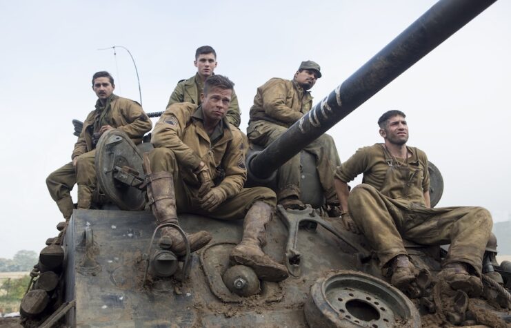 Fury publicity still of the cast sitting on a tank.