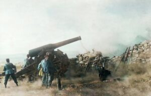 Italian artillery piece being fired as men watch.