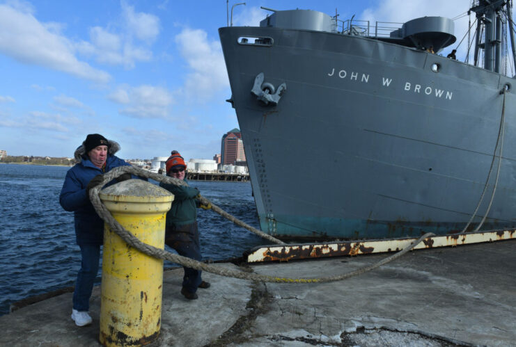 Brian Hope and Ed Koronowski releasing the forward line of the SS John W. Brown