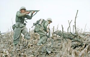 A US Marine from the 2nd Battalion, 1st Marines on Wana Ridge firing a Thompson submachine gun. Battle of Okinawa, May 1945