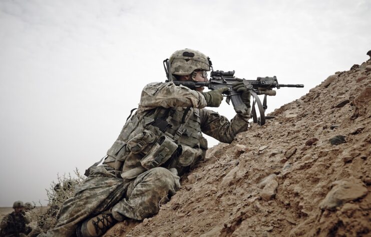 US Army soldiers from 1st Battalion, 320th Field Artillery Regiment, 2nd Brigade Combat Team of the 101st get in to fighting positions during a firefight with the Taliban.
