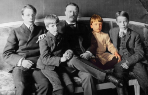 Theodore "Teddy" Roosevelt sitting with his sons on a couch