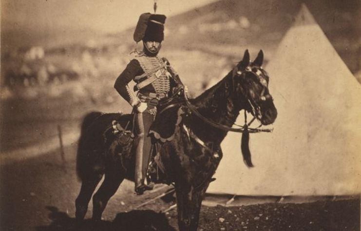 Cornet Henry John Wilkin on horseback at a military camp