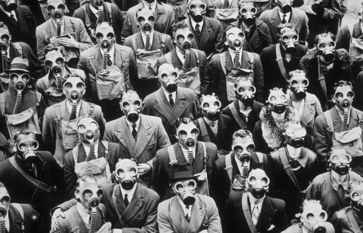 Some of London's telephone operators and engineers, trying out their gas masks at the anti-gas civilian training centre in Gloucester, 1937.