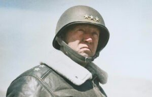 Lt. Gen. George S. Patton wearing a military helmet and jacket.