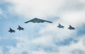 F-22 Raptors and a B-2 Stealth Bomber (C) fly over the Hudson River during the "Salute to America" military flyover on July 4, 2020 in New York City.