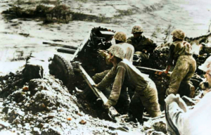 US Marines manning a weapon from a foxhole
