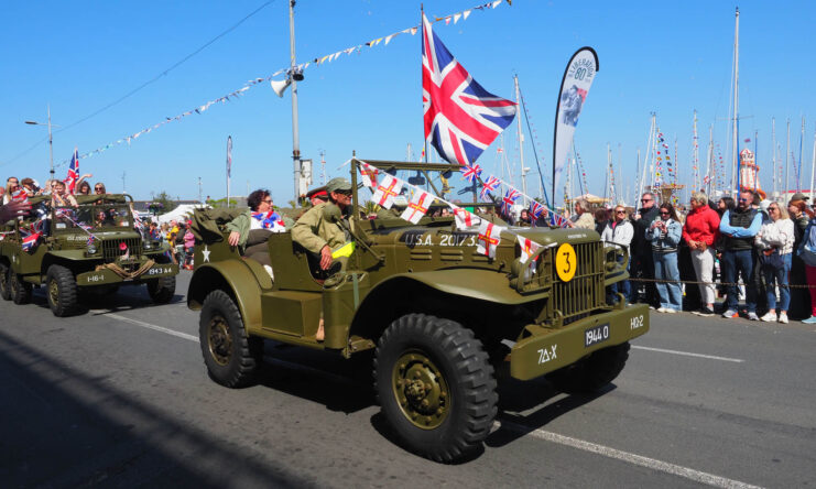 Military vehicles driving down a road