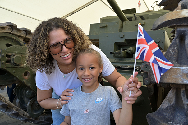 Mother and daughter standing in front of a Churchill Mark III tank