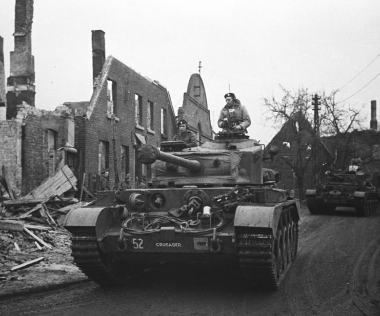 A34 Comets driving through a debris-strewn street