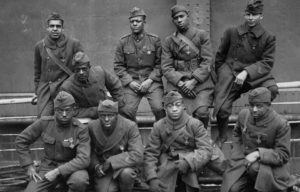 Nine members of the 369th Infantry Regiment sitting together