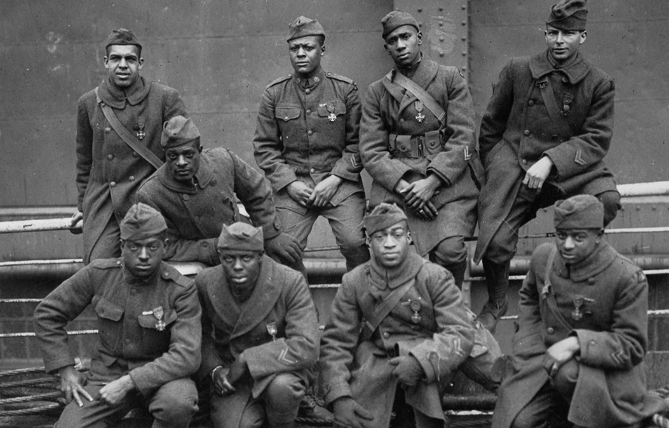 Nine members of the 369th Infantry Regiment sitting together
