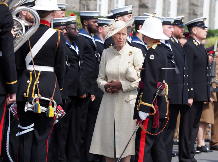 Sailors standing at attention while Princess Anne walks past them