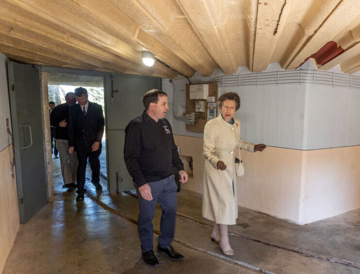 Princess Anne walking through the Mirus battery with tour guides