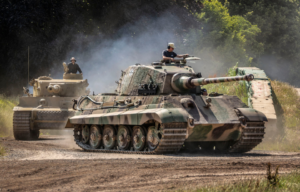 A King Tiger and Tiger 131 driving around a dirt track