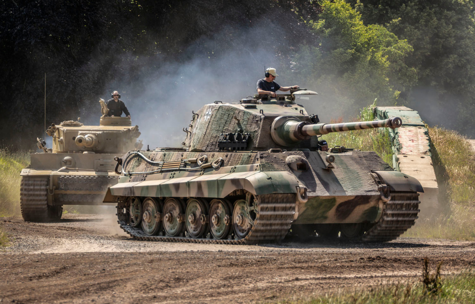 A King Tiger and Tiger 131 driving around a dirt track