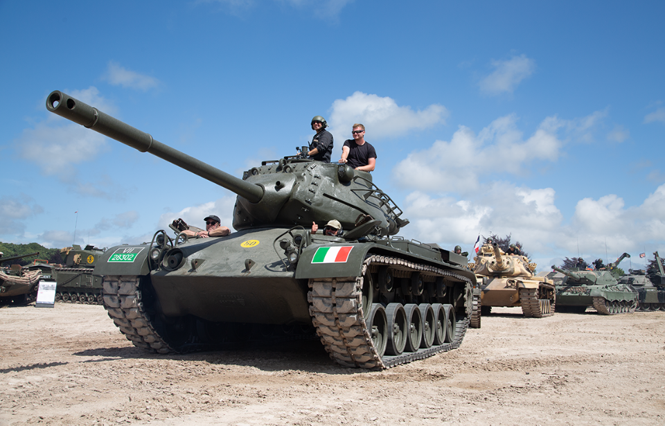 M47 Patton leading a row of tanks down a dirt path