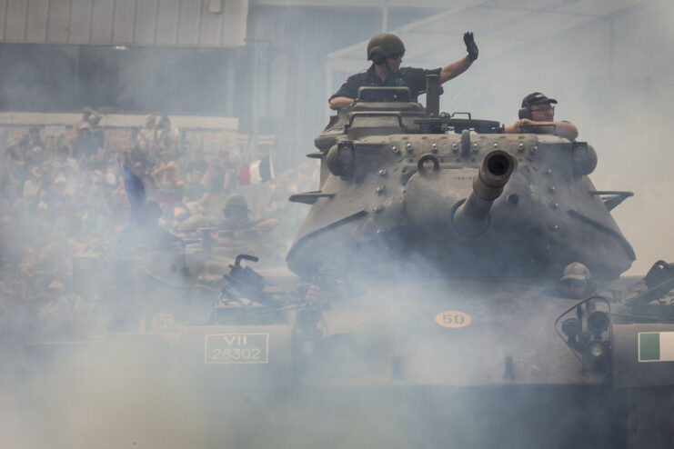 Man waving from the top of a moving M47 Patton