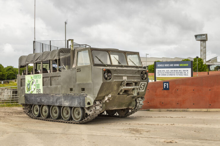 M548 troop carrier driving along a dirt track