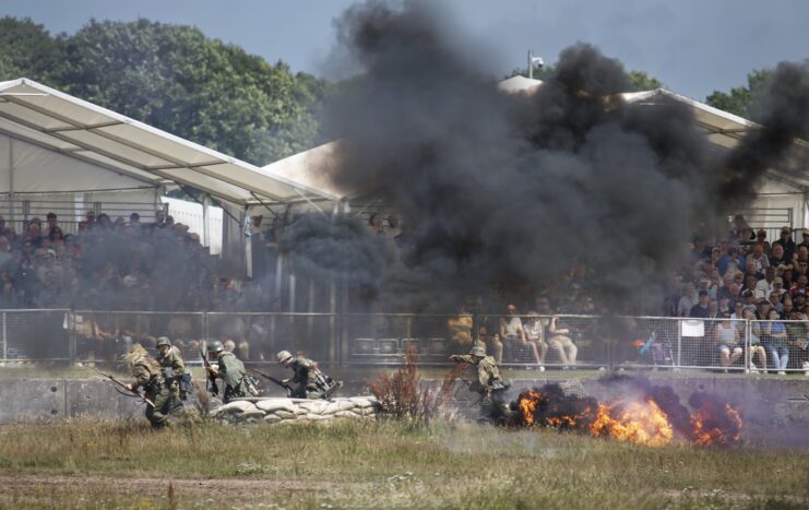 Re-enactors putting on a mock battle from World War II