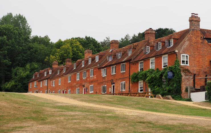 Row of redbrick buildings along a grassy area