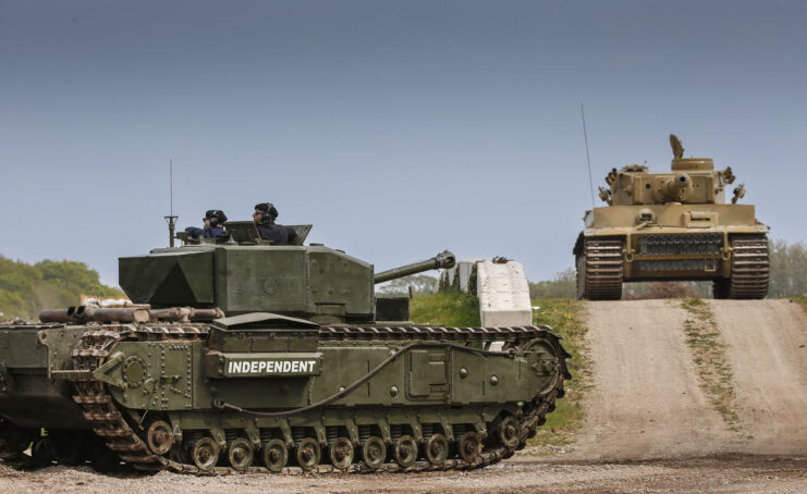 Churchill Mk III and Tiger 131 driving along a dirt track