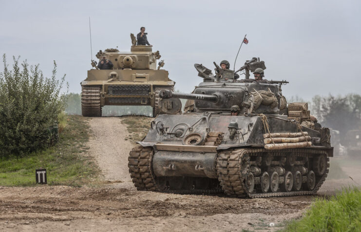 Sherman M4A2 'Fury' and Tiger 131 driving along a dirt track